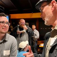 Two alums talking together.